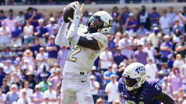 Travis Hunter goes up for a pass vs. TCU